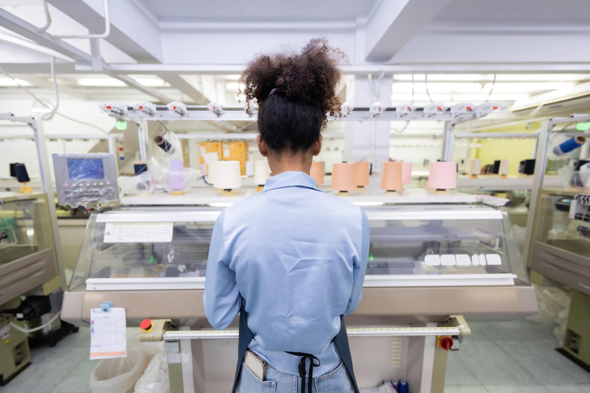 Team member checking embroidered labels in studio